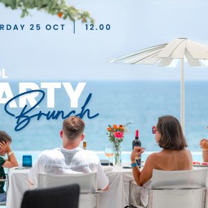Family enjoying poolside brunch with ocean view at a beach resort, October 2025.