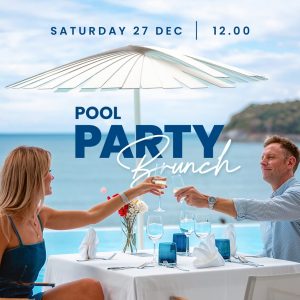 Romantic couple toasting drinks at a seaside brunch table by the pool, December 2025.