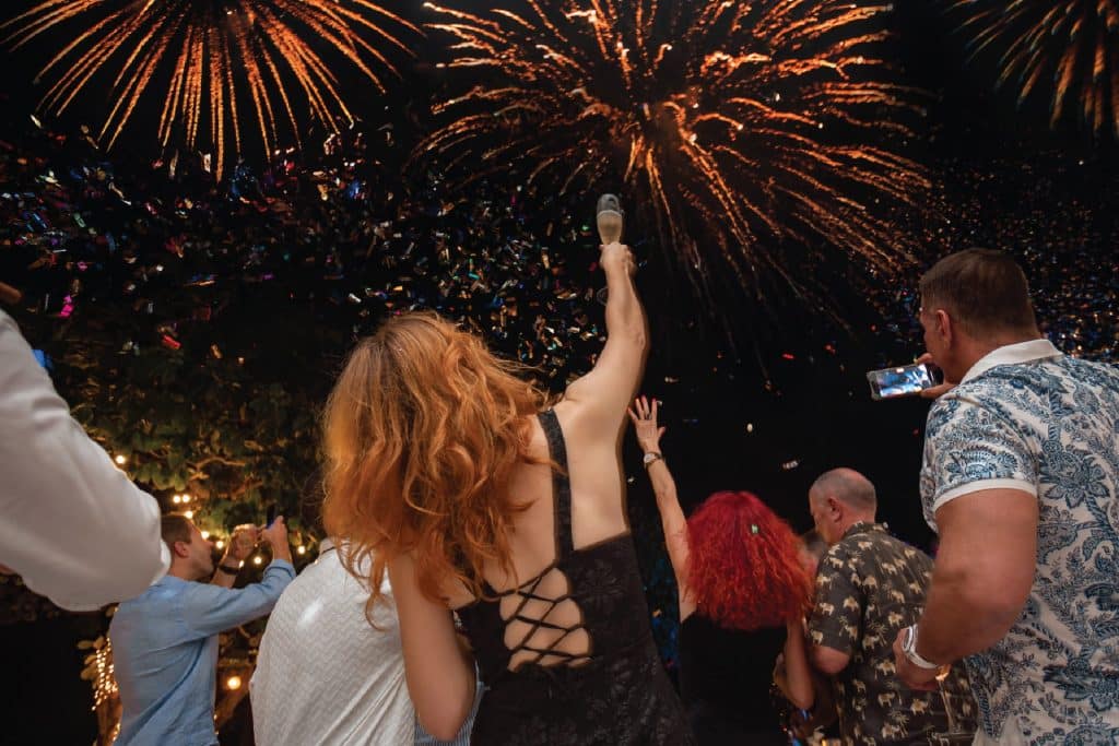 Guests celebrating under fireworks during New Year’s Eve at Kata Rocks, luxury resort in Phuket