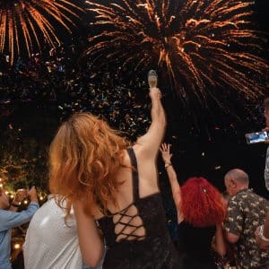 Guests celebrating under fireworks during New Year’s Eve at Kata Rocks, luxury resort in Phuket