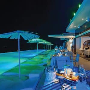 Elegant poolside dinner setup at Kata Rocks luxury resort in Phuket, ready for New Year’s Eve celebration