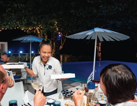Guests enjoying New Year’s Eve dinner by the pool at Kata Rocks, 5-star luxury resort in Phuket