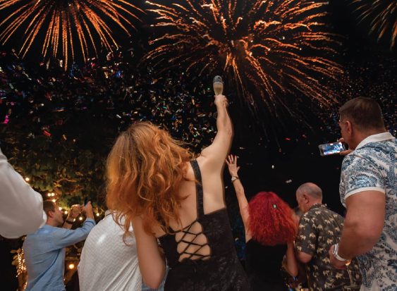 Guests celebrating under fireworks during New Year’s Eve at Kata Rocks, luxury resort in Phuket