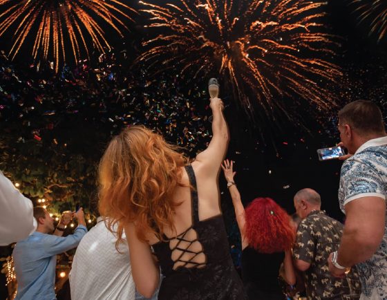 Guests celebrating under fireworks during New Year’s Eve at Kata Rocks, luxury resort in Phuket
