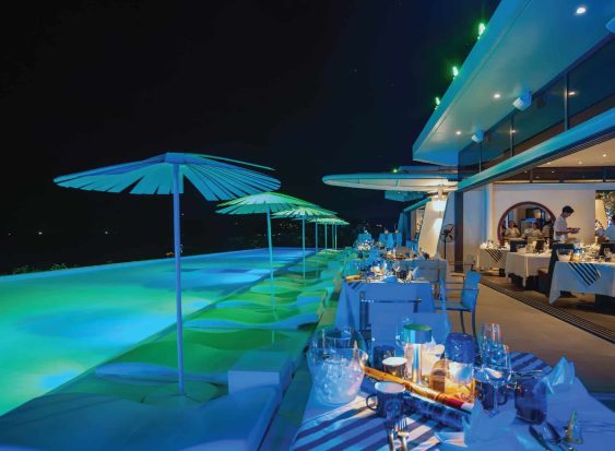 Elegant poolside dinner setup at Kata Rocks luxury resort in Phuket, ready for New Year’s Eve celebration