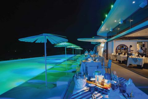 Elegant poolside dinner setup at Kata Rocks luxury resort in Phuket, ready for New Year’s Eve celebration