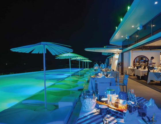 Elegant poolside dinner setup at Kata Rocks luxury resort in Phuket, ready for New Year’s Eve celebration